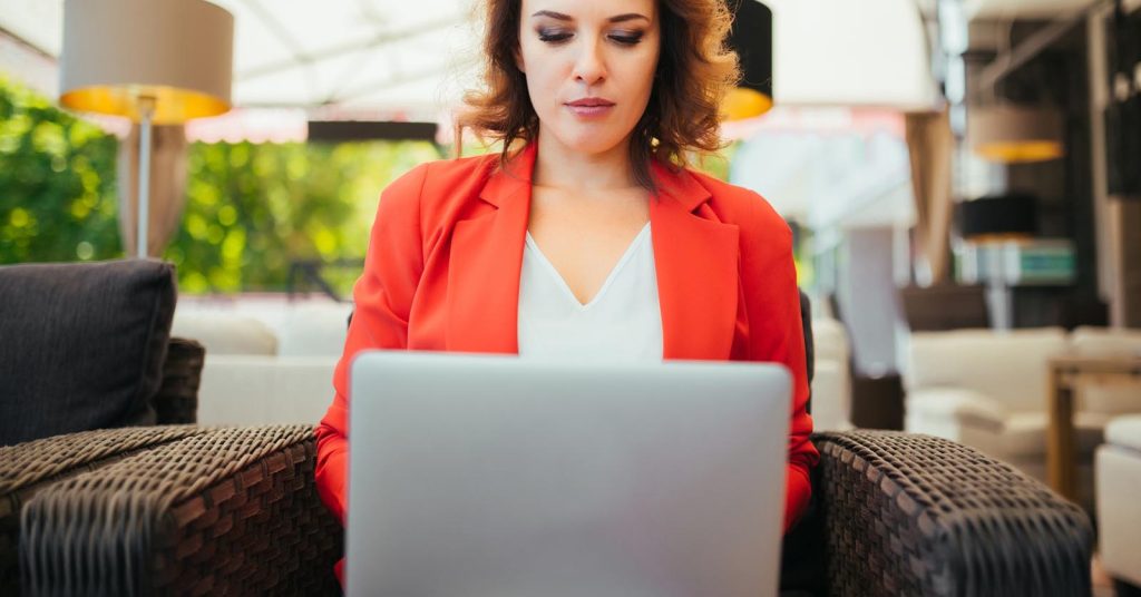 Woman reviewing debt consolidation options on a laptop
