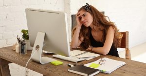Frustrated woman reviewing a debt payoff plan that is not reducing balances as expected