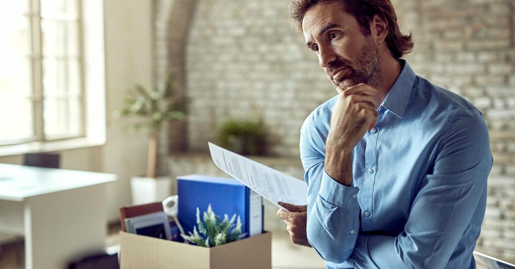 Man reviewing financial documents while considering debt relief options