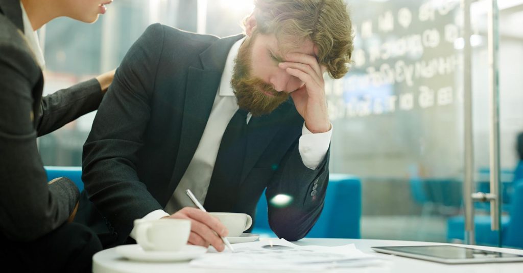 Man discussing debt relief and bankruptcy options while reviewing financial documents