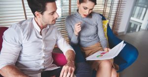 Couple reviewing financial documents together at home