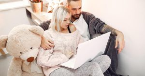 Couple reviewing information together on a laptop at home