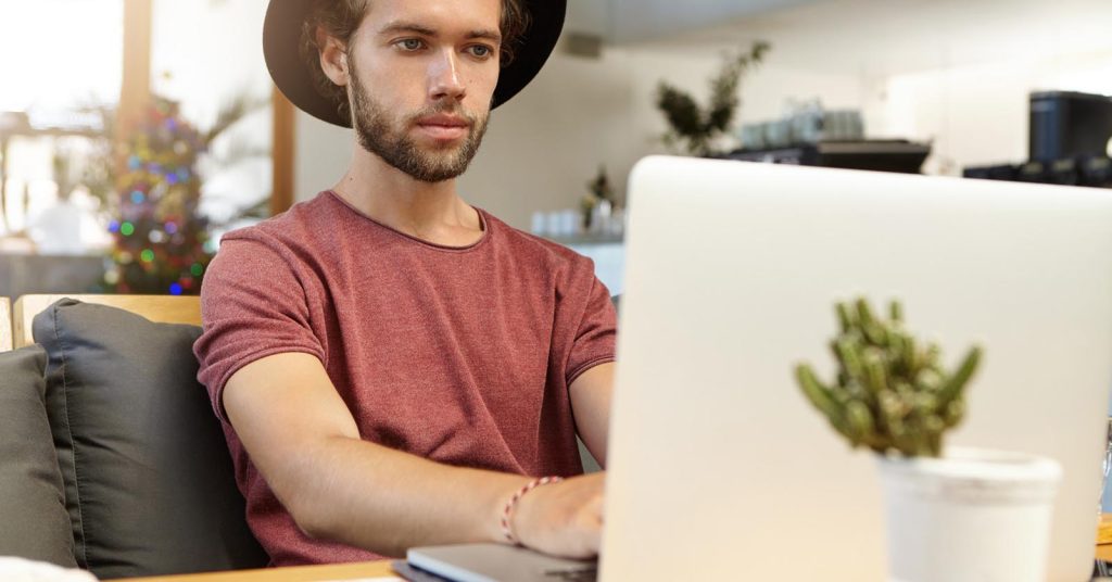 Freelancer reviewing an overdue client invoice on a laptop