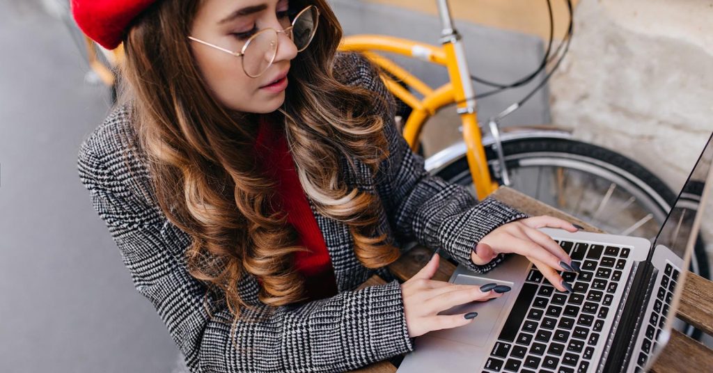 Freelancer working on a laptop while building a portfolio of sample projects