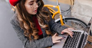 Freelancer working on a laptop while building a portfolio of sample projects