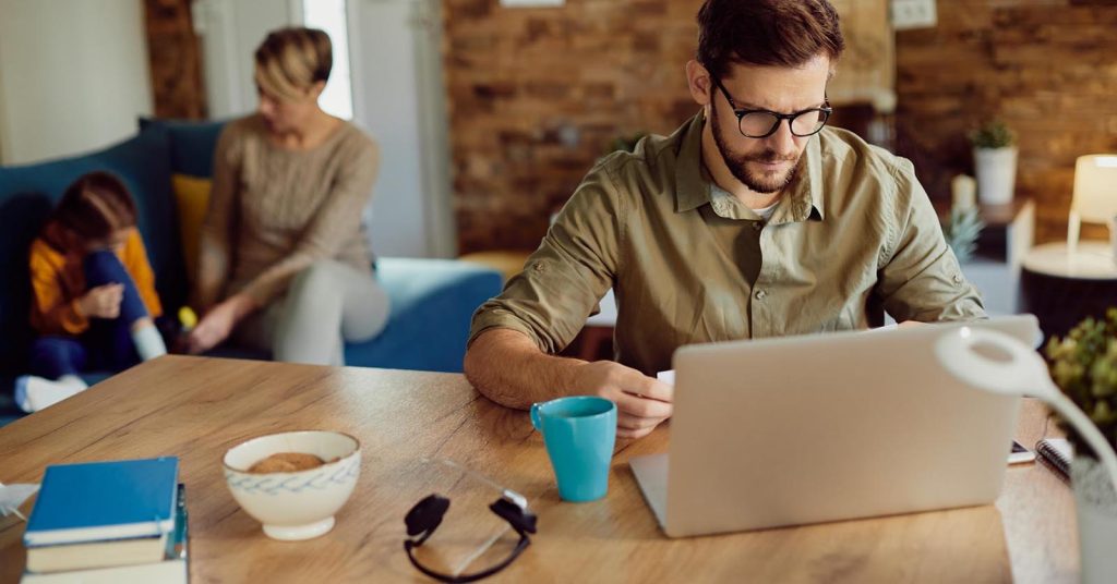 Man working from home while comparing gig work with a part-time job