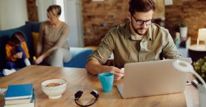 Man working from home while comparing gig work with a part-time job