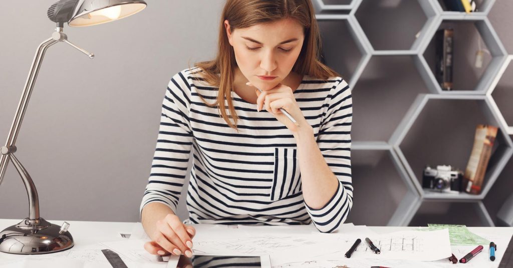 Woman comparing home equity loan and HELOC terms while reviewing household finances