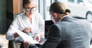 Woman reviewing a document with another person at a table