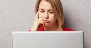 Woman estimating how long it will take to pay off debt while reviewing a plan on her laptop