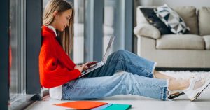 Woman working on a laptop at home while starting a freelance business
