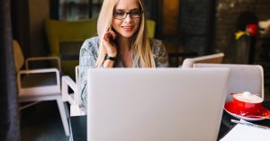 Freelancer working with a client on a laptop while building an ongoing business relationship