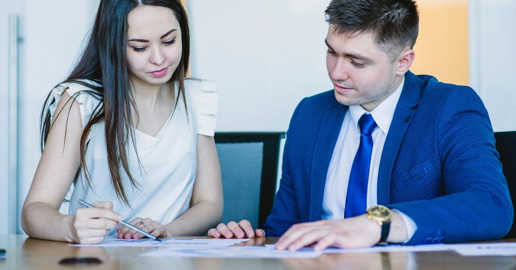 Two people reviewing documents at a table
