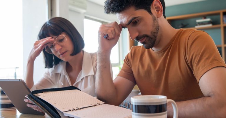 Couple reviewing individual and joint debts while building a shared payoff plan