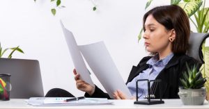 Woman comparing bills and payment options while building a realistic low-income debt payoff plan