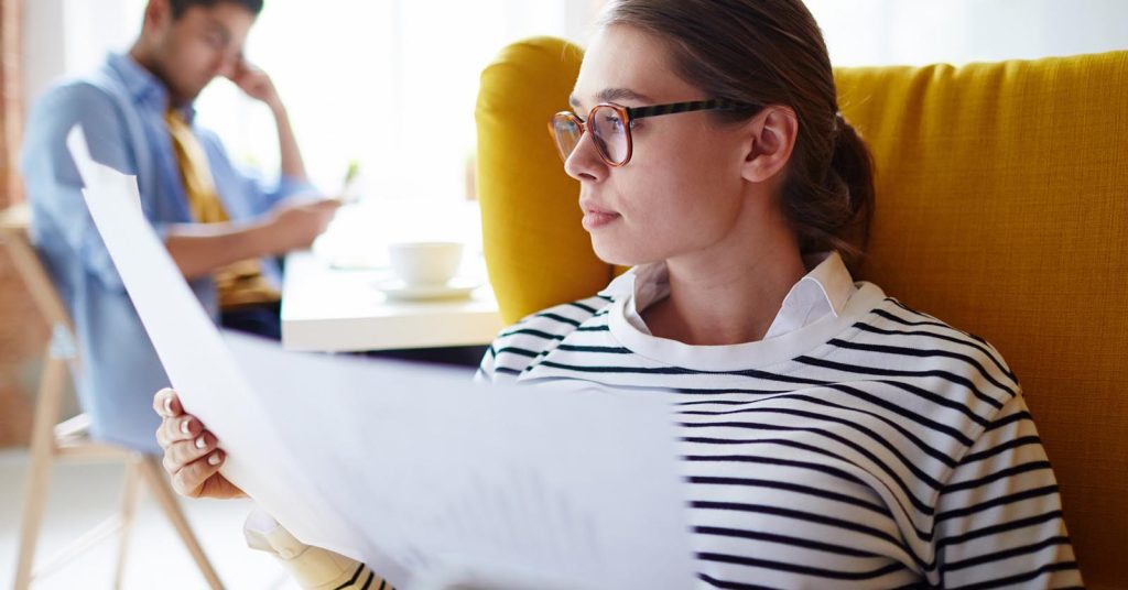 Employee reviewing notes and documents before a performance review