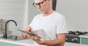 Older man reviewing retirement information on a tablet