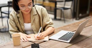Professional researching salary ranges and taking notes before a compensation negotiation
