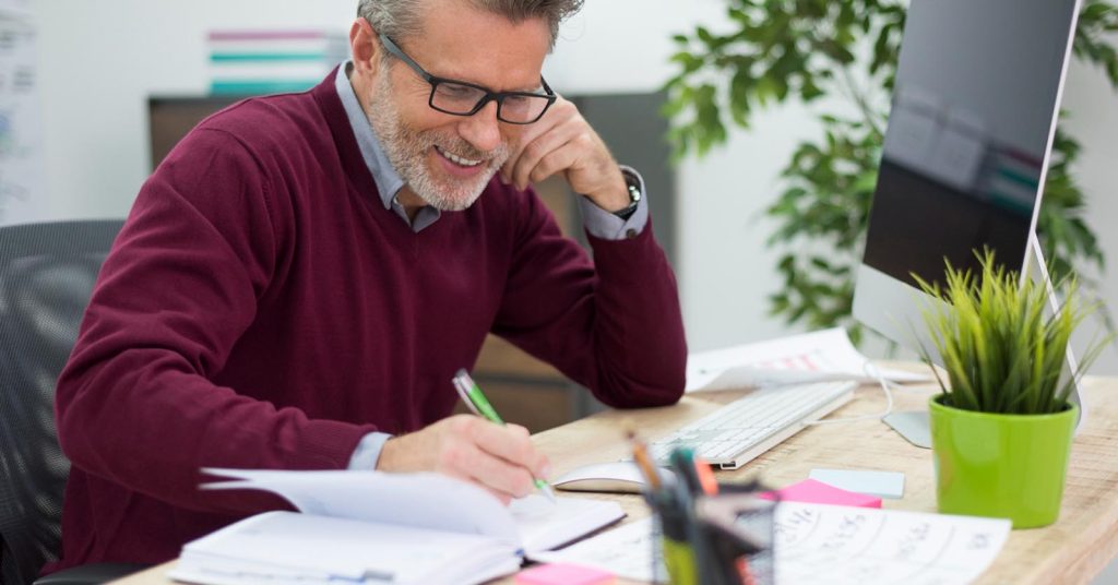 Man reviewing financial documents at a desk