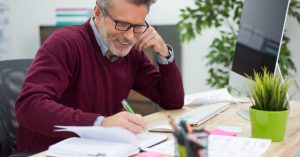Man reviewing financial documents at a desk