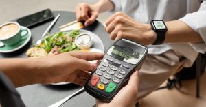 Customer paying by card for a meal at a restaurant