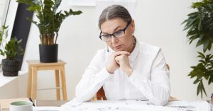 Woman reviewing financial records and settlement documents after resolving a debt