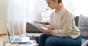 Person comparing debt relief options and repayment strategies on a laptop
