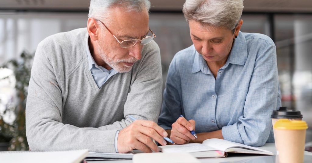 Older couple reviewing retirement notes together