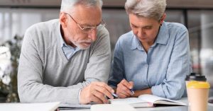 Older couple reviewing retirement notes together