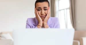 Frustrated woman deciding whether her side hustle is still worth the time and effort