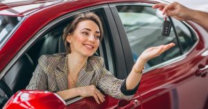 Woman receiving keys for a rental car