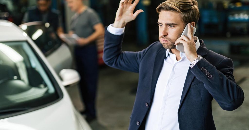 Driver arranging temporary transportation while his car is being repaired