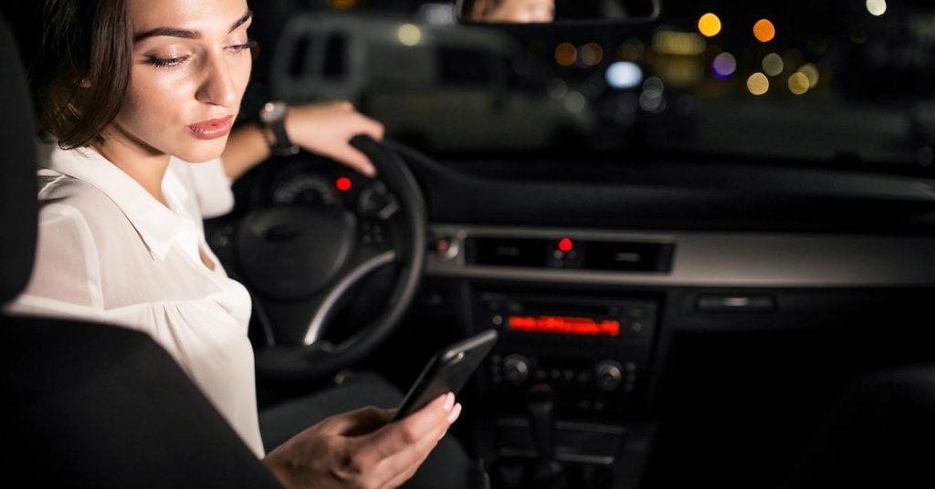Driver calling for roadside assistance from a parked car at night