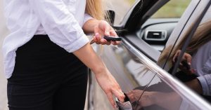 Driver unlocking a borrowed car with a key fob
