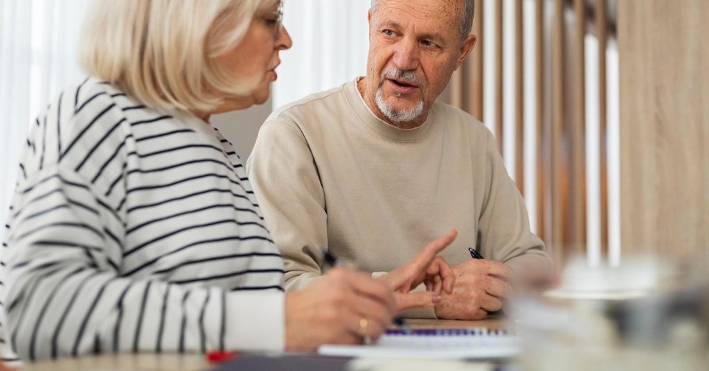 Senior couple discussing financial plans at a table