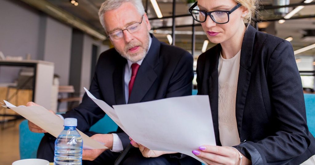 Professionals reviewing documents related to life insurance taxes