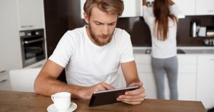 Couple reviewing household finances on a tablet at home