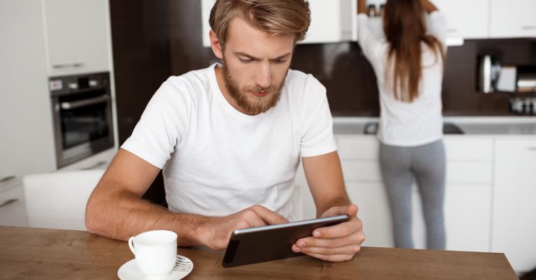 Couple reviewing household finances on a tablet at home
