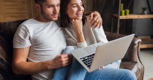 Couple reviewing information together on a laptop at home